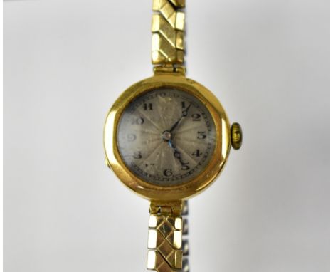 THOMAS RUSSELL & SON; a vintage ladies' 18ct gold wristwatch, the engine turned silvered dial set with Arabic numerals, in an