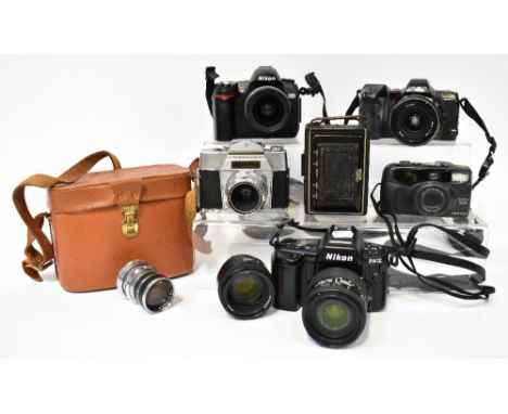 A large collection of cameras and camera equipment to include a Nikon F90X with lens, a Nikon D70 with lens, a Minolta Dynax 