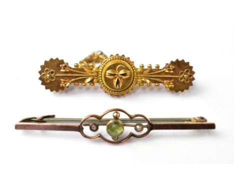 Two antique gold bar brooches comprising a 9ct gold bar brooch with bezel set peridot flanked by a tiny seed pearl either sid