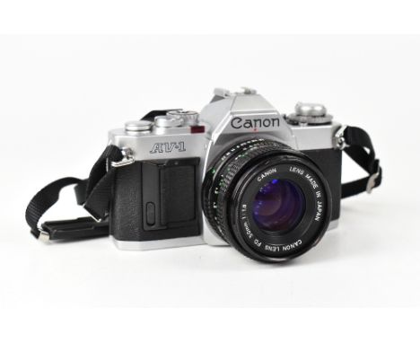 CANON; an AV1 film camera serial no.1578563, fitted with a Canon 50mm 1:1.8 lens. CONDITION REPORT The camera body is in over