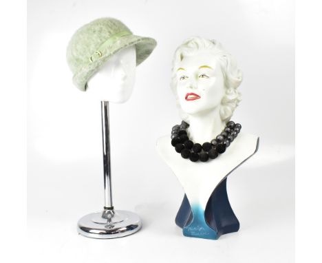 A vintage Marilyn Monroe fibreglass jewellery display bust, height 51cm and a vintage hat mannequin head on a stainless steel