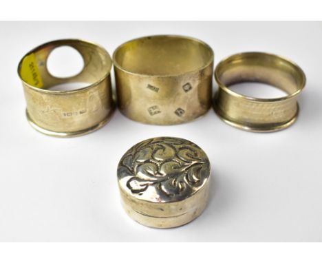 Three hallmarked silver napkin rings, the heaviest example by S J Rose &amp; Son, London 1963, an example with a hole in the 