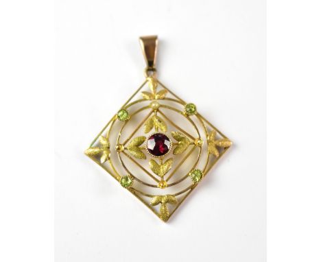 A 9ct gold Edwardian-style square necklace pendant with a bezel set centred red stone, with an outer circle of green peridots