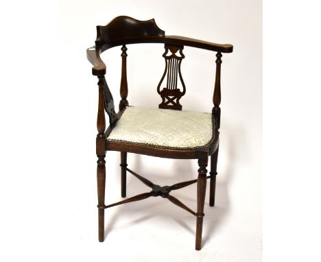 An Edwardian mahogany and satinwood strung corner chair, with shaped back above turned uprights interspersed with lyre-shaped