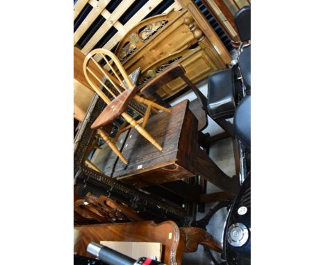 An early 20th century school desk with integral chair and hinged writing slope, with pen tray and inkwell holder to the back 