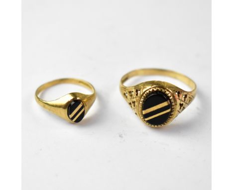 Two gentlemen's vintage 9ct gold signet rings of similar design, the largest with a centred oval onyx panel, with two diagona