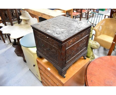 A 19th century and later carved box table, the top carved with dolphins to each corner and a central Celtic scroll and flower