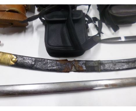 AN ASIAN CURVED SWORD, late 19th Century possibly early 20th Century, poor quality workmanship and the leather scabbard is sn