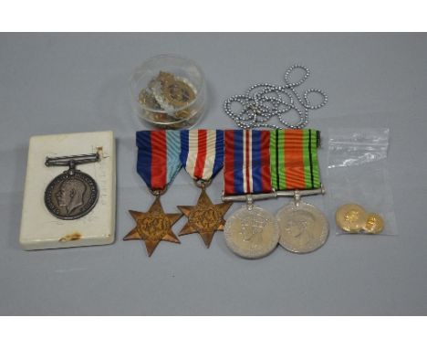 A PLASTIC BOX CONTAINING A NUMBER OF MEDALS AND BADGES, to include WWII 1939-45 and France and Germany Stars, Defence and War