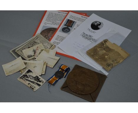 A WWI MEMORIAL DEATH PLAQUE, named to William Paddock, together with its card envelope and the original postal packet, a Brit