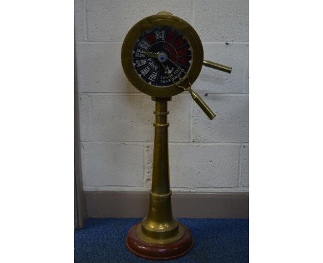 A REPRODUCTION BRASS ENGINE ROOM TELEGRAPH, mounted on a circular wooden base, height approximately 96cm