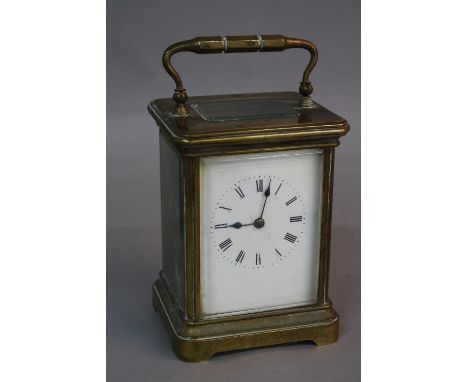 A BRASS CARRIAGE CLOCK, enamel dial, striking bell, approximately 12.5cm (key)