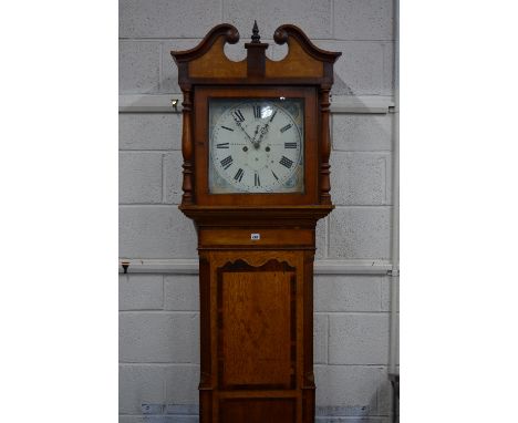 AN EARLY 19TH CENTURY OAK, WALNUT AND MAHOGANY BANDED LONGCASE CLOCK, broken swan neck pediment supported on turned columns, 