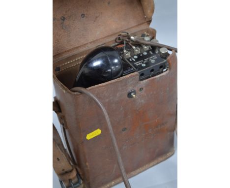 A US SIGNAL CORPS (US ARMY) WWII ERA FIELD TELEPHONE, complete in brown leather case, Model E-E-8-A, black metal case with ph