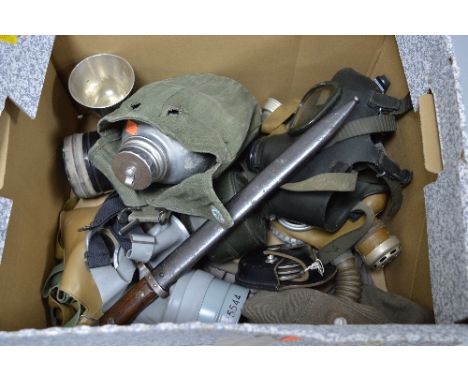 A DEALERS/TRADERS LARGE BOX CONTAINING FIVE MILITARY ISSUE GAS MASKS, WWII era and beyond, canvas kit bag, waterbottle in can