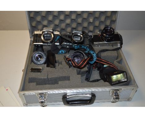 AN ALUMINIUM CAMERA CASE WITH THREE MINOLTA CAMERAS AND LENSES, these are an X-300, XG-1 and another X-300, the lenses are a 