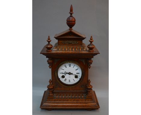A LATE 19TH CENTURY WALNUT CASED MANTEL CLOCK OF ARCHITECTURAL FORM, white enamel dial with Roman numerals, dial and eight da