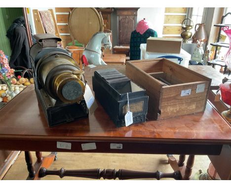 A late 19th/early 20th century Magic Lantern projector, with a selection of various Magic Lantern slides, also a case contain