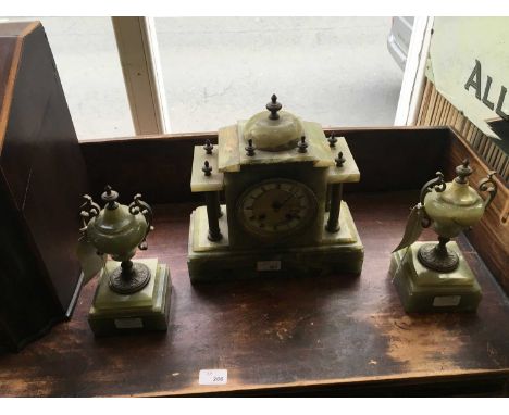 An early 20th century onyx clock garniture, comprising architectural mantel clock, the silvered dial set with Roman numerals,