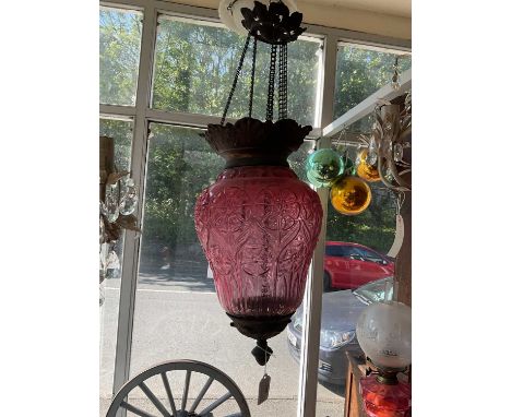A decorative cranberry glass hanging lantern with moulded floral decoration and metal mounts, height 60cm.