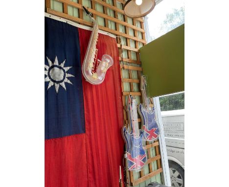 Two novelty illuminated wall clocks in the form of electric guitars, and an LED light in the form of a saxophone (3)