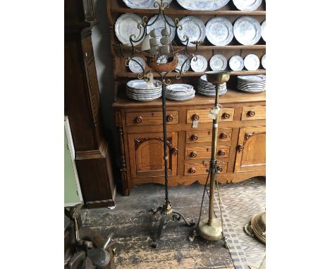 A Victorian brass telescopic oil lamp base section terminating on three paw feet, height 130cm, together with a black painted