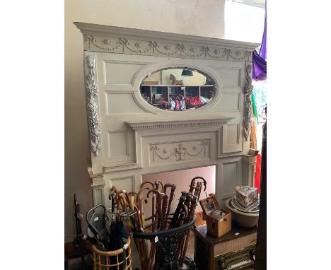 A decorative white painted fire surround with bevelled mirror plates above fixed shelf and applied sprigging and decoration, 