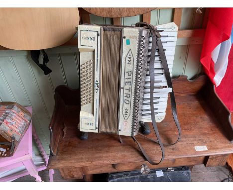 PIETRO; a piano accordion with associated case and stand. 