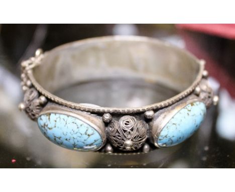 Stone set white metal bangle with filigree work between cabochon stones