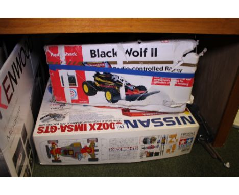 Boxed Nissan 1/10 scale racing car and Radio Shack Black Wolf II radio controlled car