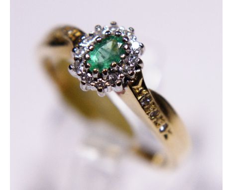 18ct gold emerald and diamond cluster ring with diamond set shoulders, size Q