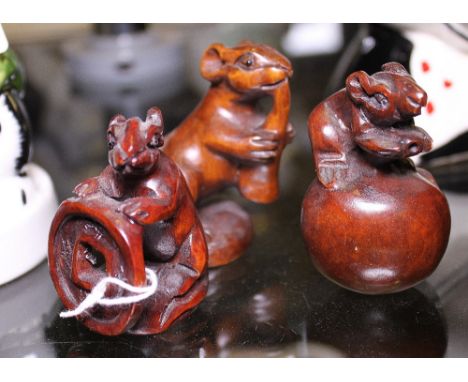 Three Oriental wood netsuke in the form of rats 