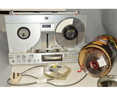 A VINTAGE AKAI GX-77 FOUR TRACK REEL TO REEL TAPE RECORDER, and a tin of tapes, The Akai powers up, the reels run and the dis