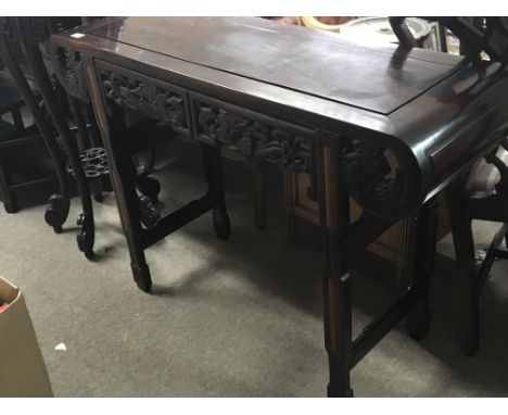 A Chinese hardwood side table or alter table with scroll ends. 115x40cm.