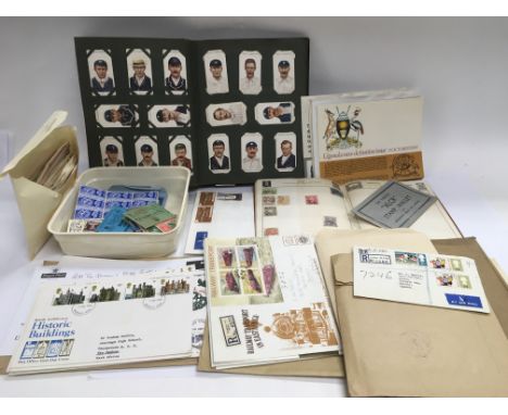 A collection of stamps, some in albums and some loose, first day covers and an album of cigarette cards.
