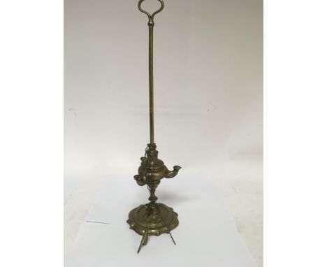 A 19th century Roman style oil lamp with three tools including a wick trimmer, pricker and snuffer.
