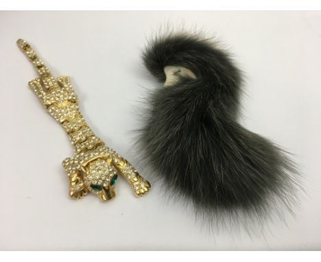 Two vintage brooches, one formed as an articulated crystal tiger, the other a lady in a fur hat