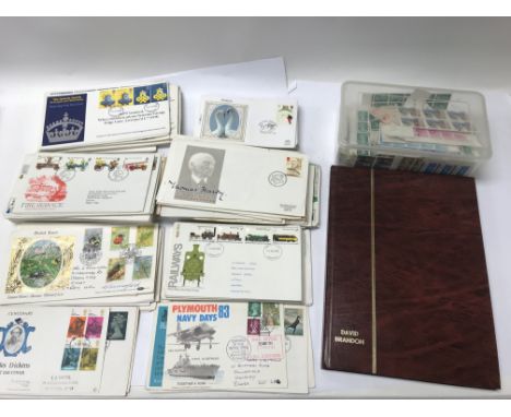 A box containing a large collection of first day covers and a stamp album of GB stamps.