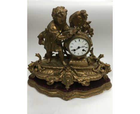 An 8 day giltwork figural mantle clock depicting a scholarly child reading a book, approx height 40cm.