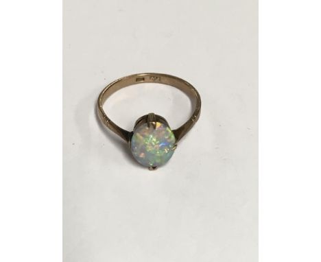 A 9 ct gold ring inset with a single opal