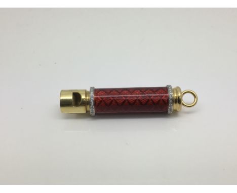 An 18ct gold diamond set whistle with engine turned enamel decoration, approx 6cm and approx 19.7g.