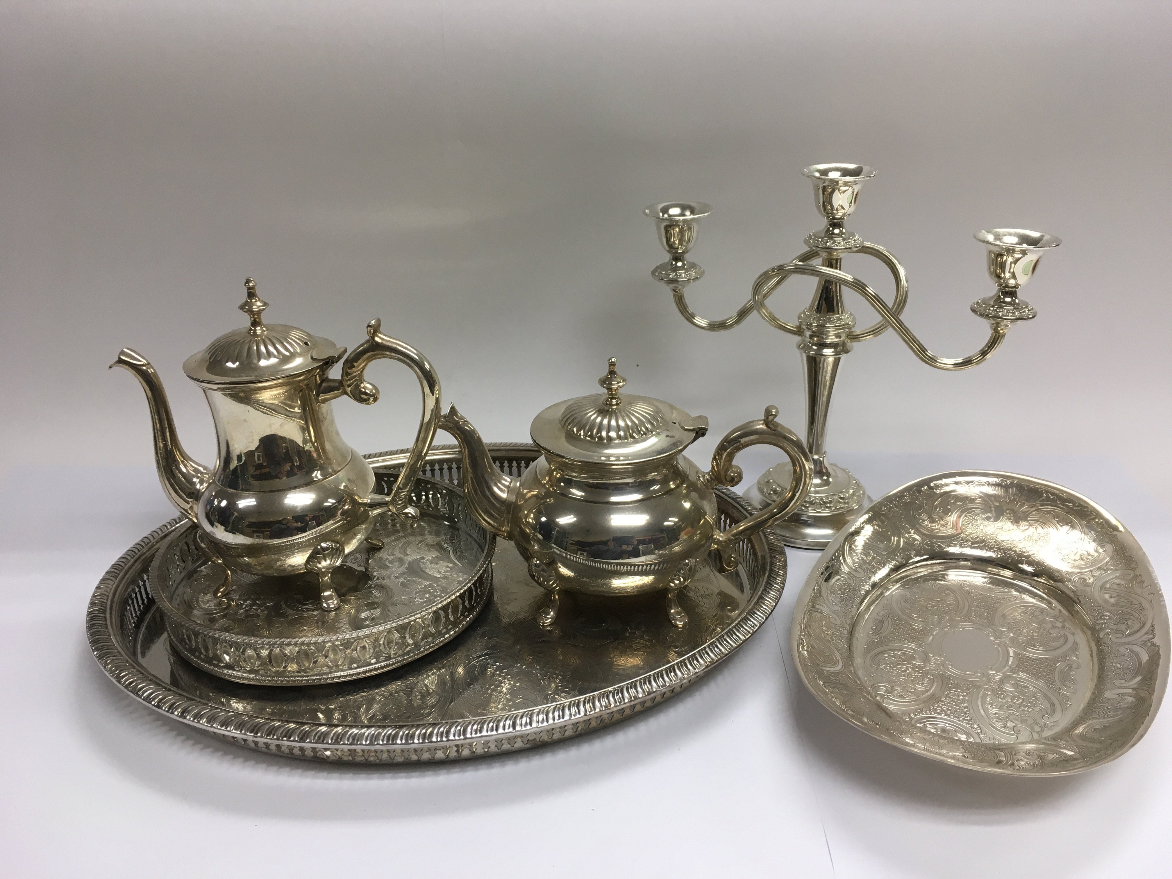 A collection of silver plated items including teapot, three branch ...