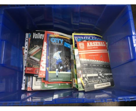 A box containing a large collection Of football season programmes and annuals including Spurs, Arsenal and others.