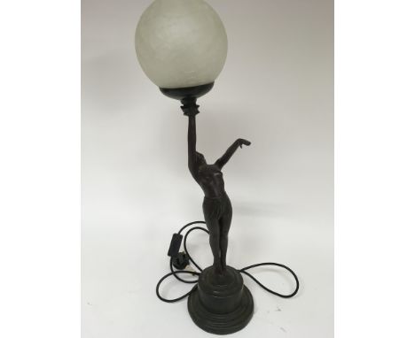 An Art Deco style table lamp of a female figure holding up the light, height approx 66cm.