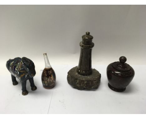 A serpentine stone lighthouse, lidded vase, an enamelled horse and a pipe bowl with a painted scene.