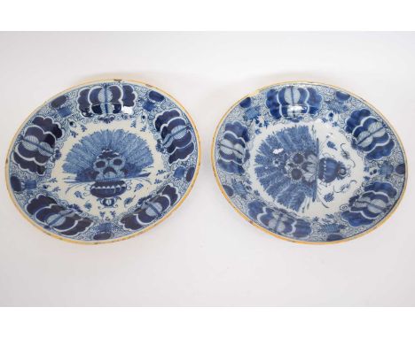 Two Dutch Delft 18th century blue and white dishes with a Kangxi style design within ochre borders, 27cm diam (2)