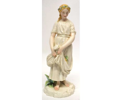 Royal Worcester style Art Nouveau model of a maiden or flower seller, on rocky base, 32cm high