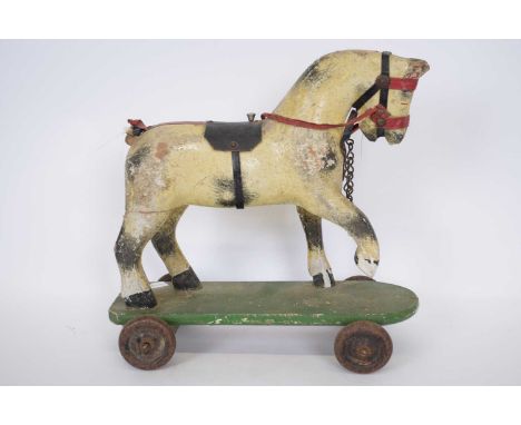 Small wooden toy of a horse, on a rectangular base