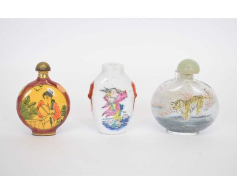 Small bag containing three Chinese scent bottles including a porcelain example with polychrome design, a further enamel examp