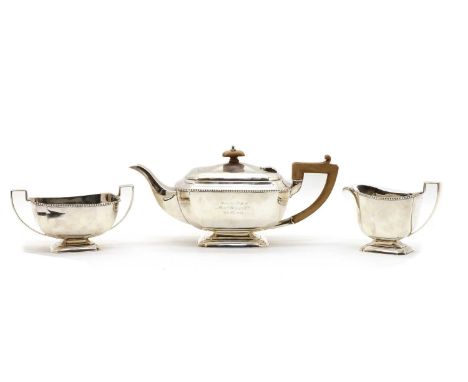 A silver three piece tea service, by Reid &amp; Sons, Birmingham 1931, teapot 31cm wide, total 35.8oztCondition report: Knock